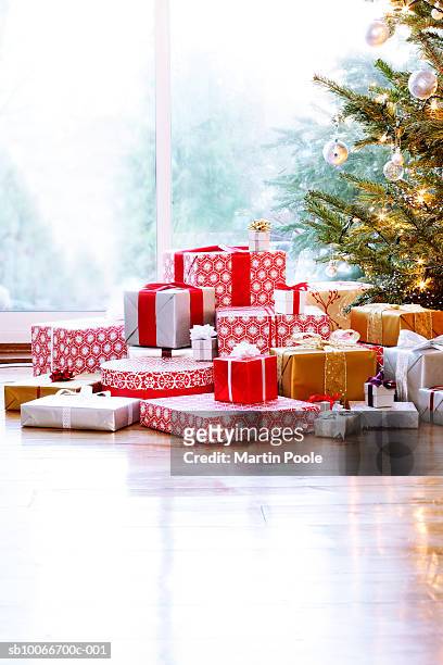 large pile of presents under christmas tree - pile of gifts stock pictures, royalty-free photos & images