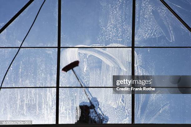 window washer on glass ceiling - window cleaner stock-fotos und bilder