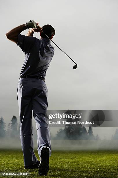 uomo giocando a golf, vista posteriore - golf swing foto e immagini stock