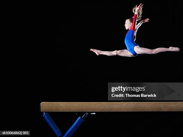 gymnast (9-10) leaping on balance beam - doing the splits stock pictures, royalty-free photos & images
