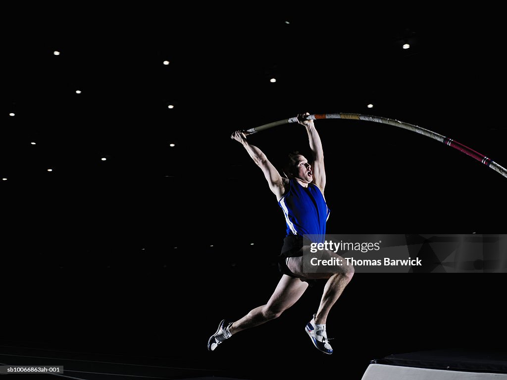 Male pole vaulter beginning vault