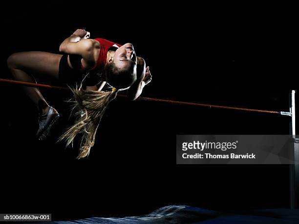 female high jumper in motion - フィールド競技 ストックフォトと画像