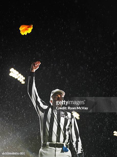 referee tossing yellow flag - football schiedsrichter stock-fotos und bilder