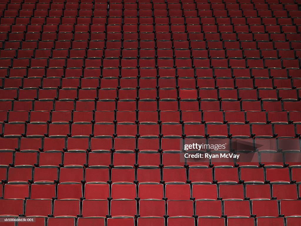 Rows of red chairs in stadium, elevated view