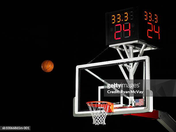 basketball in air moving towards hoop, low angle view - scoring stockfoto's en -beelden