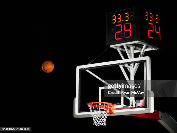 basketball in air moving towards hoop, low angle view - goes to the basket imagens e fotografias de stock