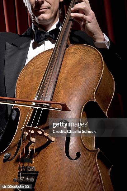 man playing cello, mid section - strings section stock pictures, royalty-free photos & images