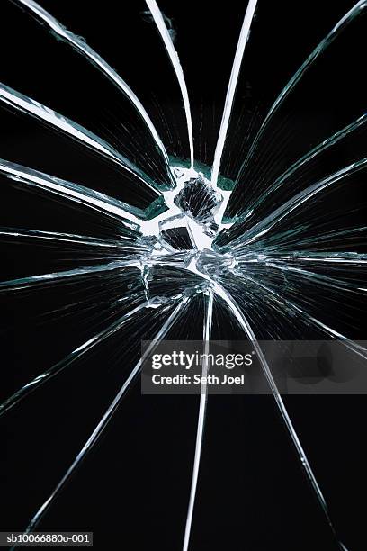 hole in broken shattered mirror, studio shot - cracked mirror stock pictures, royalty-free photos & images