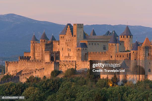 france, languedoc, carcassonne, castle on top of hill at sunset - castle ward stock pictures, royalty-free photos & images