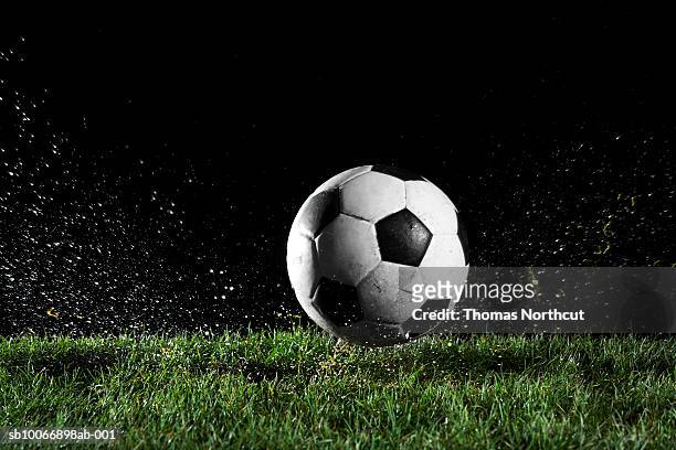soccer ball in motion over grass - soccer ball stock pictures, royalty-free photos & images