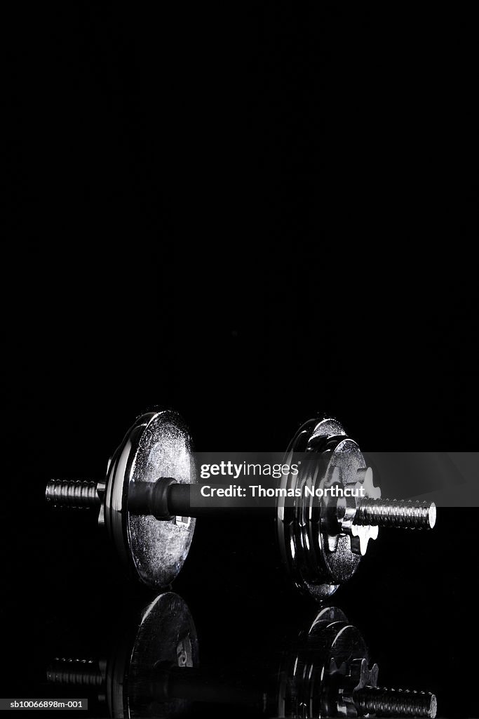 Barbell on black background