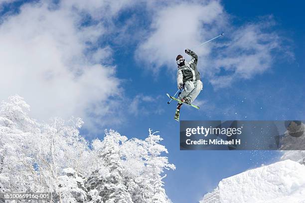 skiier mid air on slope - japan skiing stock pictures, royalty-free photos & images