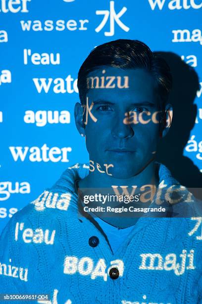 visual projection of pattern reading water in various languages cast on man, portrait - light letters stock-fotos und bilder