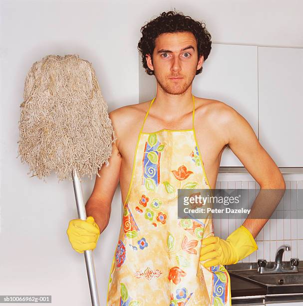 young man with apron and mop, portrait - aljofifa fotografías e imágenes de stock