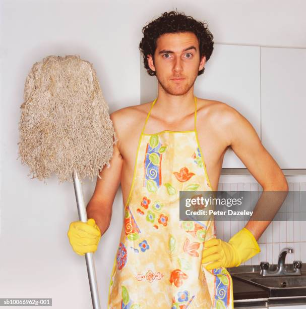 young man with apron and mop, portrait - apron stock pictures, royalty-free photos & images