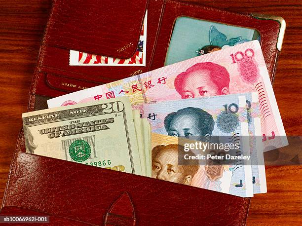 us dollars and chinese yaun in wallet - cny stock pictures, royalty-free photos & images