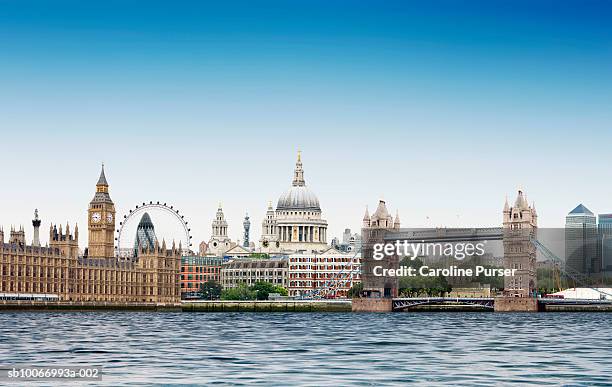 london montage against plain blue sky with river thames in foreground - london landmark ストックフォトと画像