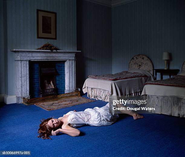 young woman laying on floor in bedroom - 死体 女性一人 ストックフォトと画像