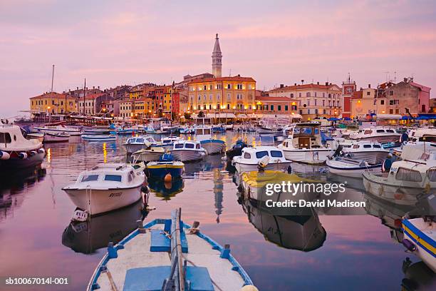 croatia, rovinj, boats docked in harbour in front of distant cathedral of st. euphernia - rovinj stock pictures, royalty-free photos & images