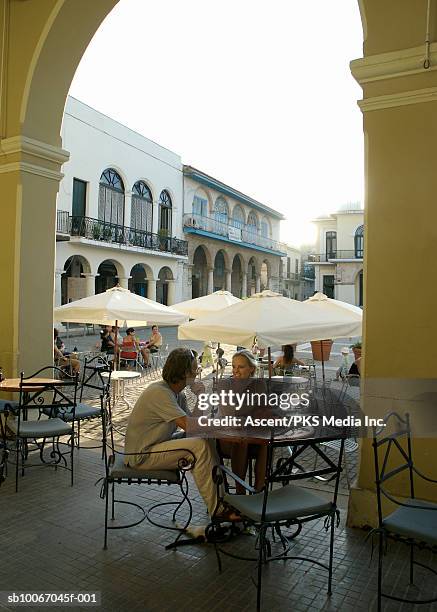 mature couple sitting at outdoor caft - cuba travel stock pictures, royalty-free photos & images