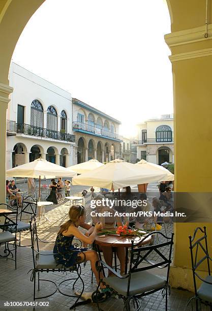 mother and daughter (12-13) sitting at outdoor caft - caft stock pictures, royalty-free photos & images