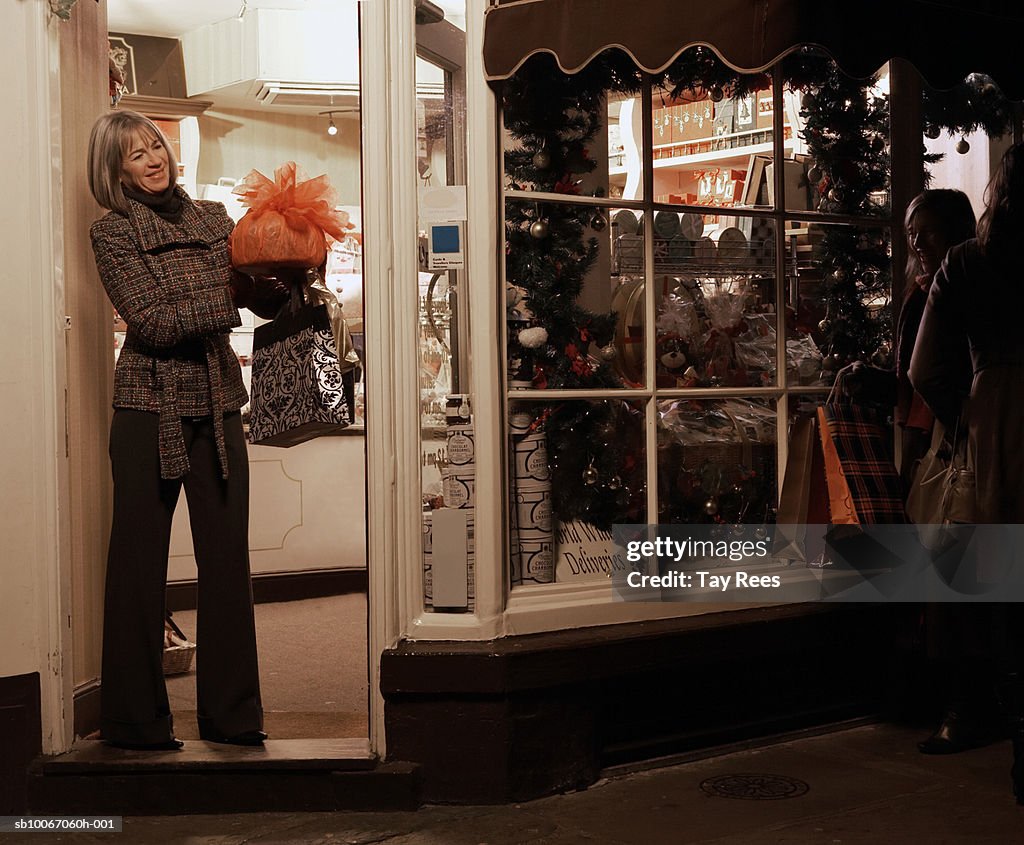 Mature woman Christmas shopping, smiling