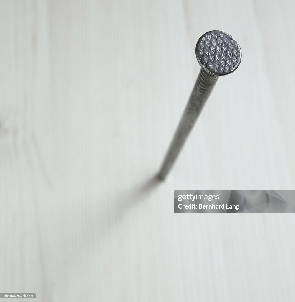 Nail in wooden board