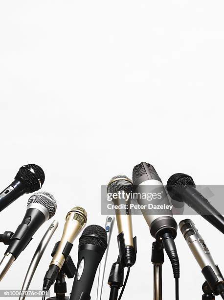 conference microphones on white background - conferencia de prensa fotografías e imágenes de stock