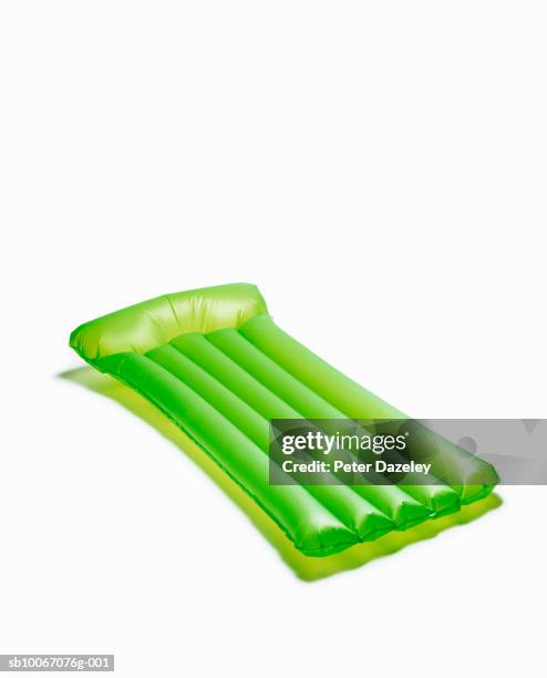 green lilo on white background - airbed stock pictures, royalty-free photos & images