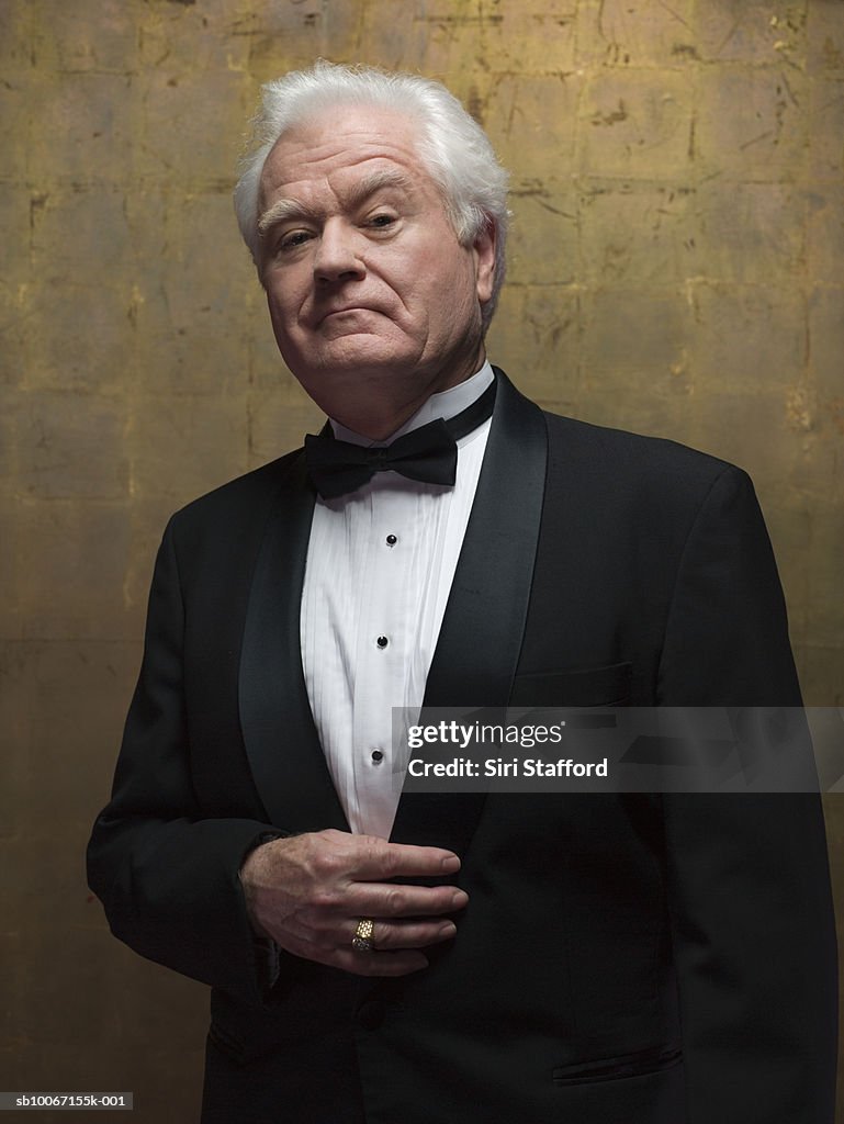 Senior man wearing tuxedo, portrait, studio shot