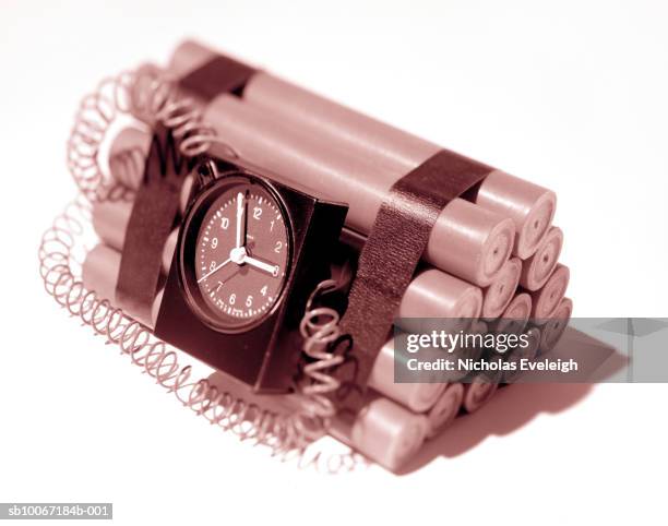 timer on sticks of dynamite forming explosive bomb, studio shot - explosive material stock pictures, royalty-free photos & images