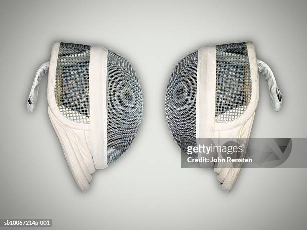 two fencing masks, studio shot - sports equipment foto e immagini stock