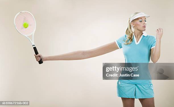 female tennis player with stretched out arm (digital composite) - largo longitud fotografías e imágenes de stock