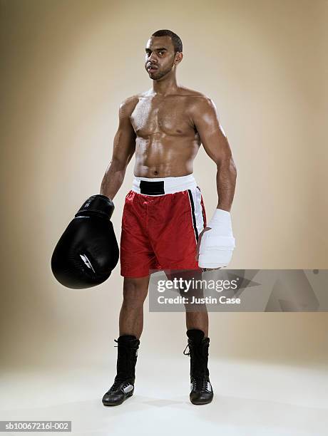 boxer with large glove, portrait (digital composite) - boxing shorts stock pictures, royalty-free photos & images