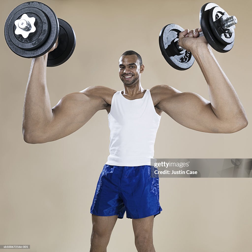 Man With Enlarged Arms Lifting Weights Portrait High-Res Stock