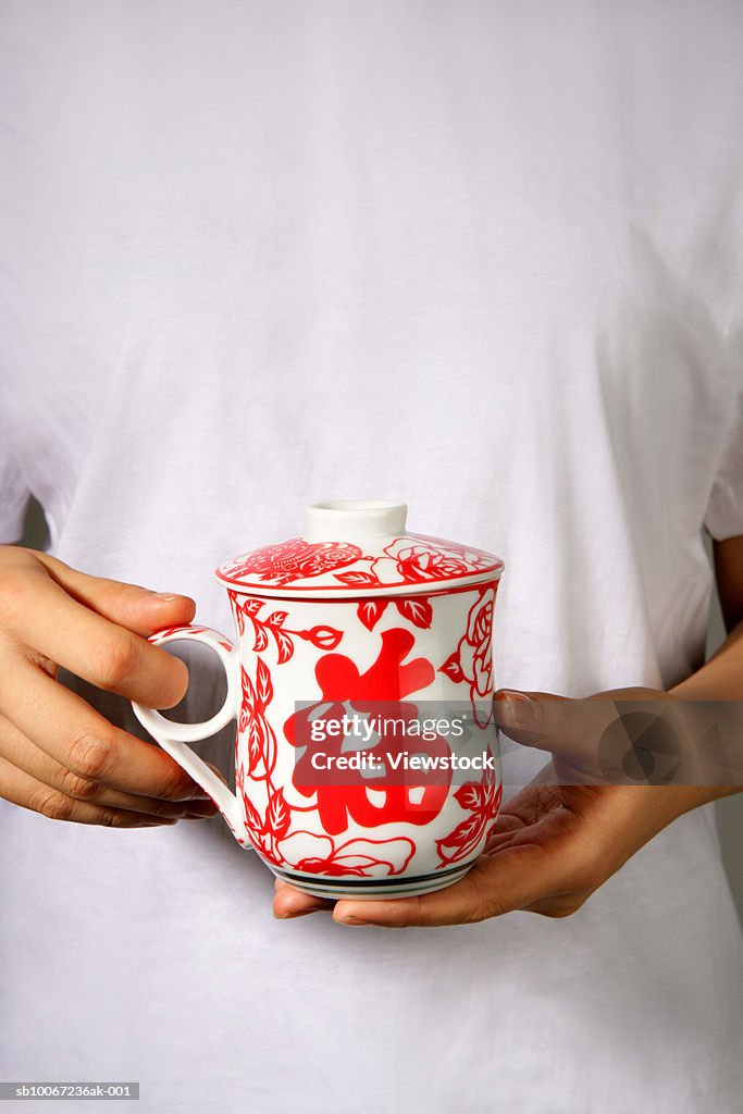 Woman with traditional Chinese tea mug