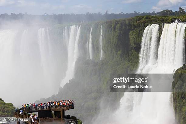 brazil, iguacu national park, people watching waterfall - iguassu falls stock pictures, royalty-free photos & images