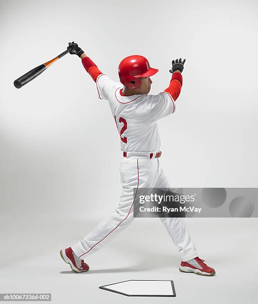 baseball batter swinging, studio shot - baseball strip stock pictures, royalty-free photos & images