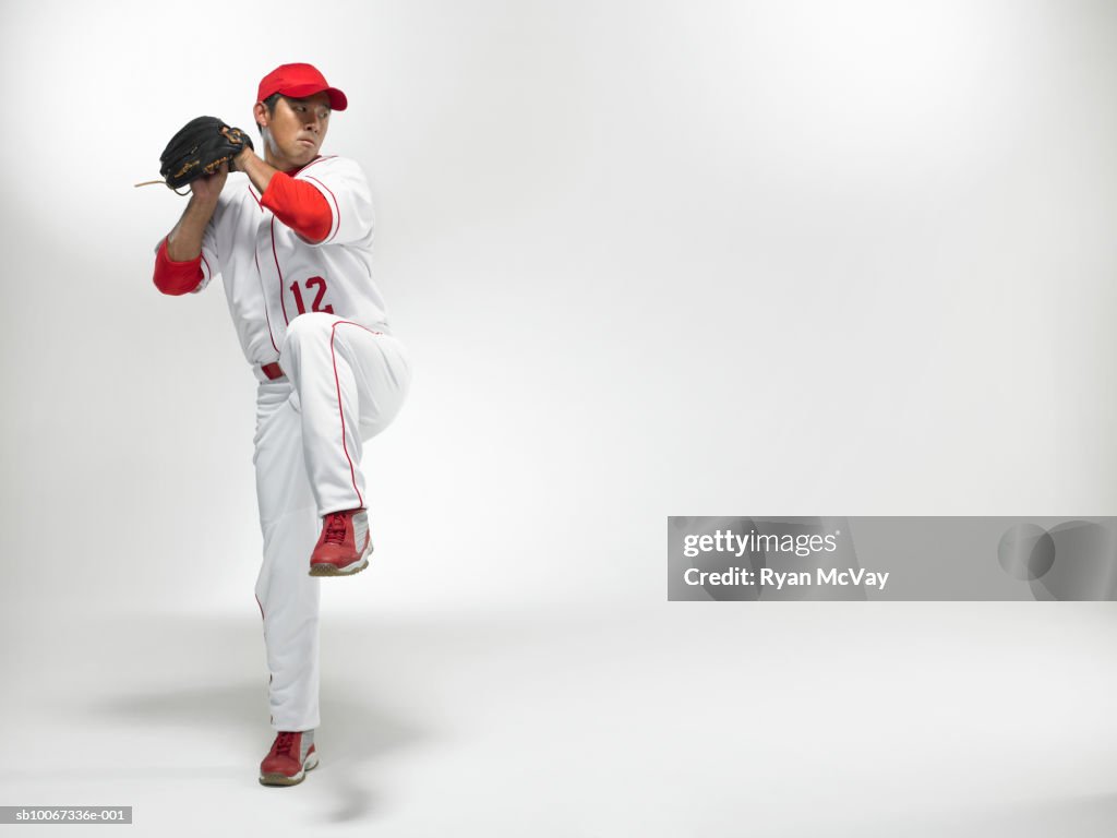Baseball pitcher winding up, studio shot