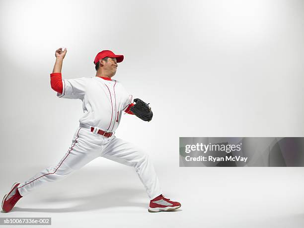 baseball pitcher throwing, studio shot - baseball thrower stock pictures, royalty-free photos & images