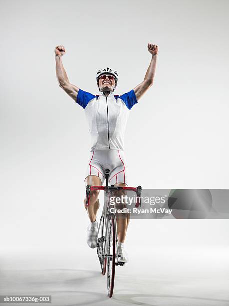 cyclist pumping fists, studio shot - biking athletic stock pictures, royalty-free photos & images