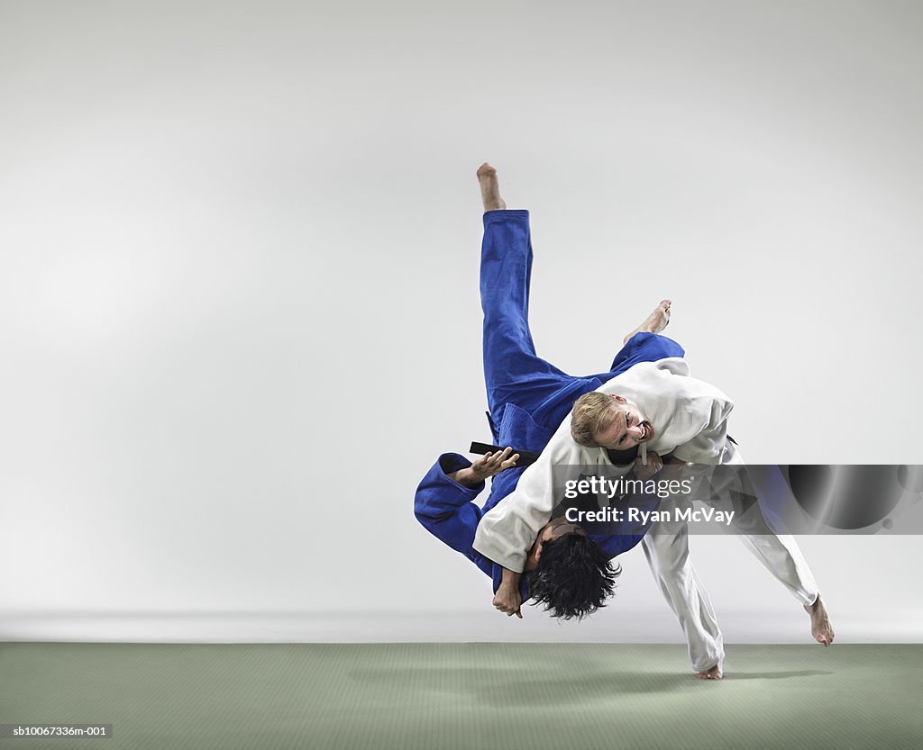 Two men fighting judo