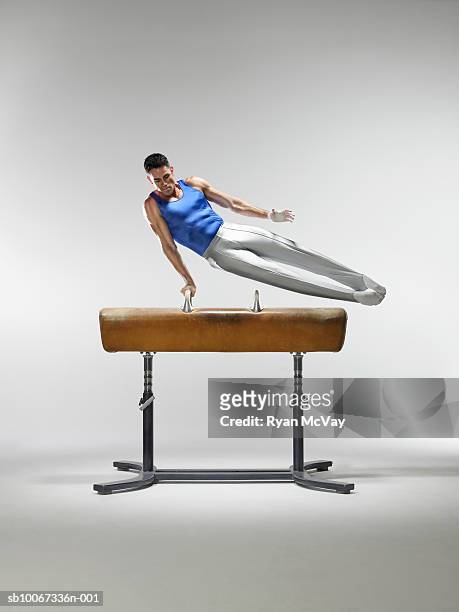 male gymnast on pommel horse, studio shot - pommel horse bildbanksfoton och bilder