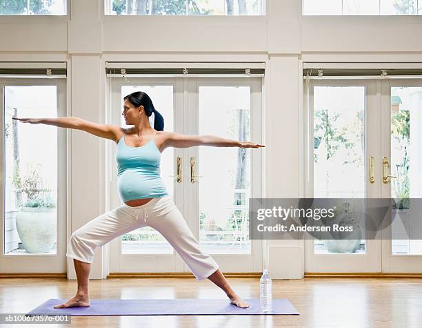 pregnant woman practicing yoga, arms out - prenatal yoga stock pictures, royalty-free photos & images