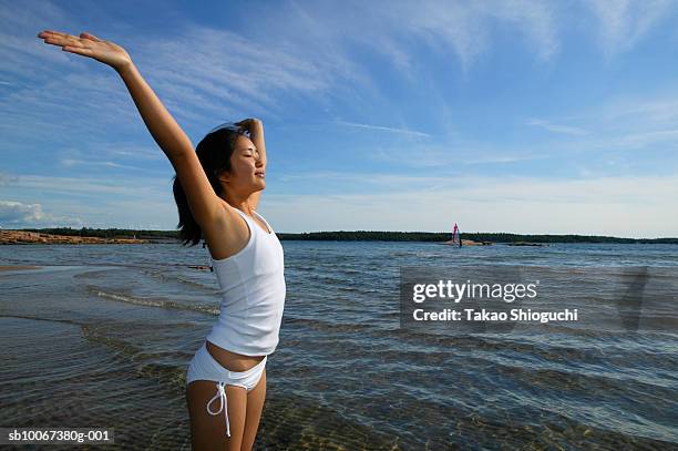 girl (16-17) standing in lake with arms outstretched - killbear provincial park stock pictures, royalty-free photos & images