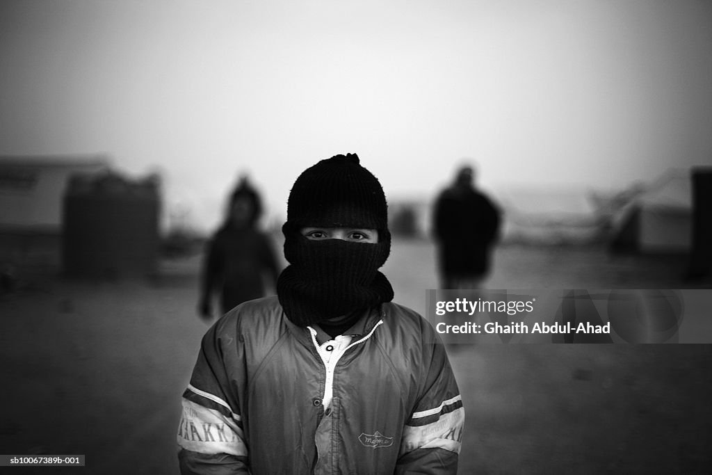Iraq, No Mans Land, boy in ski cap in refugee camp