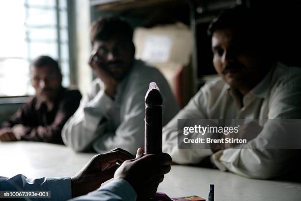 Condom demonstration for village men on June 30, 2006