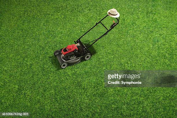 lawn mower on grass, elevated view - grasmaaier stockfoto's en -beelden