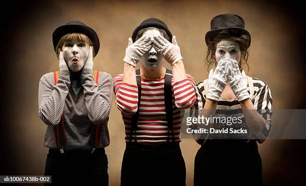 three mimes acting out 'hear no evil, see no evil, speak no evil' - pantomime stock pictures, royalty-free photos & images