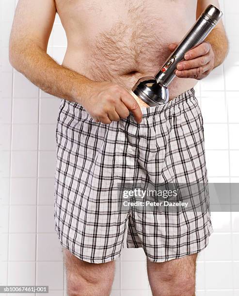 man using flashlight to examine testicles, mid section, close-up - groin stock pictures, royalty-free photos & images